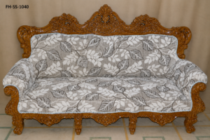 Elegant hand-carved wooden sofa set with floral upholstery and intricate royal detailing
