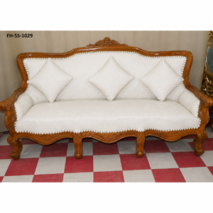 Luxury handcrafted wooden sofa with ivory upholstery, decorative nailhead trim, and matching accent cushions