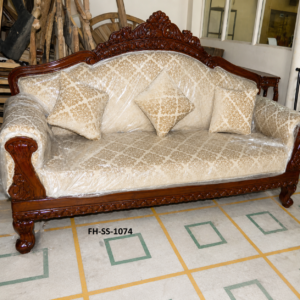 Elegant handcrafted wooden sofa with cream floral upholstery, decorative cushions, carved wooden frame, and classic royal-inspired design.