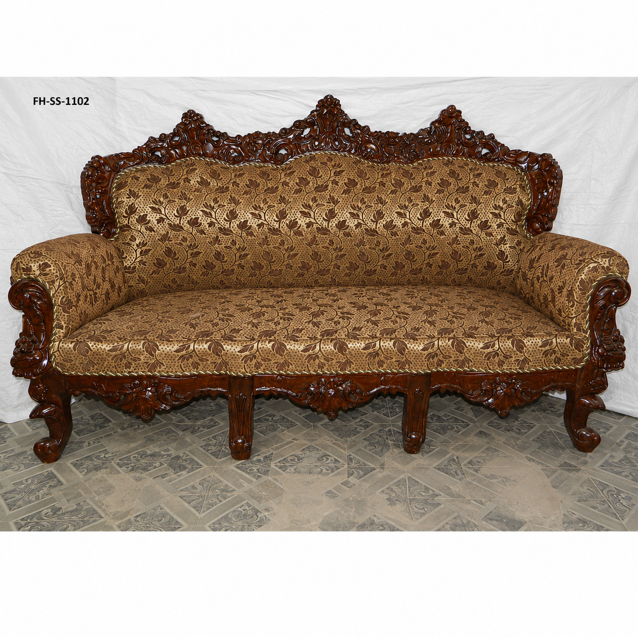 Luxury handcrafted wooden sofa set with intricate floral carvings, rich brown patterned upholstery, rolled armrests, and a majestic royal-inspired design.