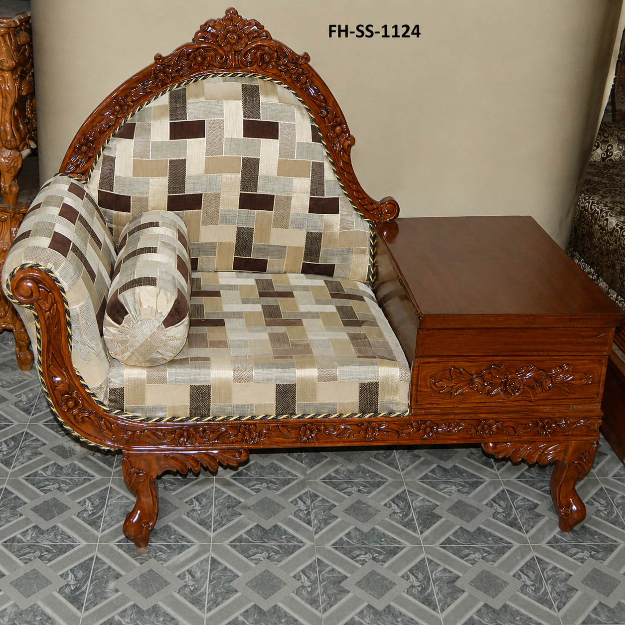 Luxurious handcrafted wooden lounge chair featuring carved detailing, geometric upholstery, cylindrical cushion, and an integrated wooden side table.
