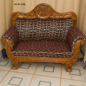 Elegant handcrafted wooden loveseat featuring intricate floral carvings, rolled scroll arms, premium patterned upholstery, and a timeless royal-inspired design.