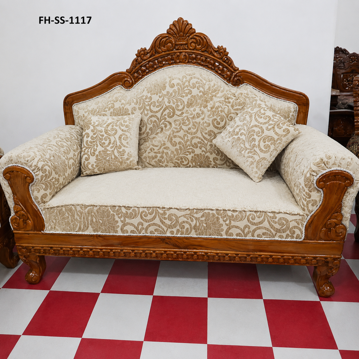 Elegant handcrafted wooden loveseat featuring a carved crown backrest, premium cream scroll-pattern upholstery, rolled armrests, and decorative accent cushions.