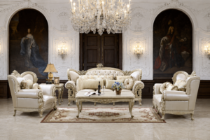 Elegant ivory luxury sofa set with tufted upholstery, carved wooden frame, matching armchairs, decorative cushions, and a handcrafted coffee table in a grand classical living room.