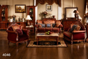 Elegant Victorian-style living room sofa set featuring richly carved solid wood frames, warm brown premium upholstery, matching armchairs, decorative cushions, and a classic wooden coffee table.