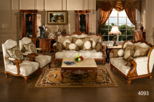 Luxury handcrafted wooden sofa set featuring carved solid wood frames, elegant beige floral upholstery, matching armchairs, decorative cushions, and a premium wooden coffee table in a sophisticated living room.