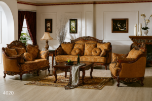 Elegant luxury living room sofa set with handcrafted carved wooden frame, golden premium upholstery, decorative cushions, and classic European-inspired design in a sophisticated interior.