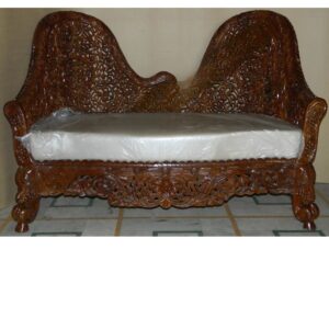 Exquisite handcrafted wooden loveseat featuring intricate openwork jali carving, floral motifs, rolled armrests, and a premium cushioned seat in a rich polished wood finish.