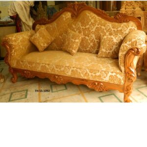 Luxurious carved wooden sofa set with elegant floral upholstery, premium solid wood frame, decorative detailing, and plush cushioned seating in a classic royal design.