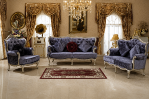 Luxury blue velvet Chesterfield sofa set with tufted backrest, carved solid wood frame, elegant silver finish, and plush cushions in a classic living room.