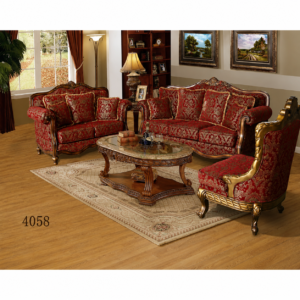Luxury red upholstered sofa set with carved solid wood frame, elegant patterned fabric, matching accent chair, and marble-top coffee table in a classic living room.