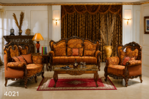 Elegant Victorian-style sofa set with hand-carved solid wood frame, luxurious patterned upholstery, plush cushions, and a matching glass-top coffee table in a classic living room.