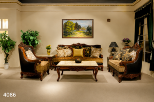 Luxury traditional wooden sofa set with intricately hand-carved solid wood frame, premium beige upholstery, decorative cushions, and matching wooden center table.