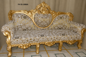 A luxurious handcrafted sofa featuring an intricately carved solid wood frame with a rich antique gold finish and premium floral jacquard upholstery. Designed with an elegant royal crest, ornate carvings, and plush seating, this European-inspired sofa adds timeless sophistication to luxury homes, hotels, villas, and palace-style interiors.