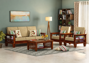 A premium solid wood living room sofa set featuring a natural wood finish, soft beige fabric upholstery, comfortable seating, and a matching wooden center table. Designed with clean lines and timeless craftsmanship, this set enhances the beauty of modern homes, offices, hotels, and lounges.