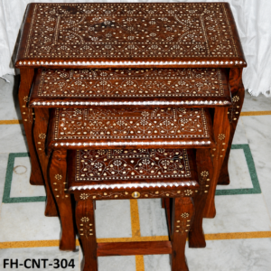 A premium Handcrafted Antique Wooden Nesting Tables Set featuring rich wooden craftsmanship, intricate floral inlay work, elegant carved detailing, and a traditional polished finish. Designed with multiple stackable tables, this set combines functionality with timeless elegance, making it perfect for living rooms, bedrooms, lounges, and luxury interiors.