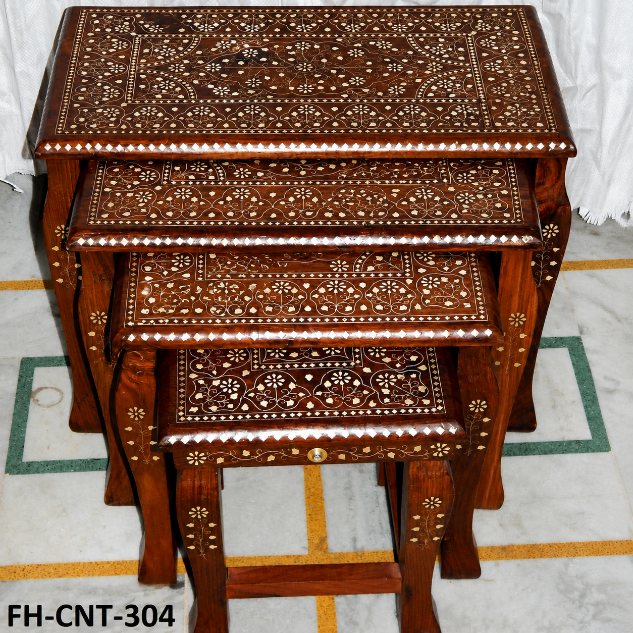 A premium Handcrafted Antique Wooden Nesting Tables Set featuring rich wooden craftsmanship, intricate floral inlay work, elegant carved detailing, and a traditional polished finish. Designed with multiple stackable tables, this set combines functionality with timeless elegance, making it perfect for living rooms, bedrooms, lounges, and luxury interiors.
