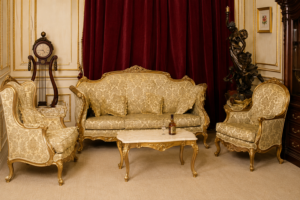 Luxury cream and gold carved wooden sofa set with classic European design, premium upholstered living room furniture, elegant royal seating collection.