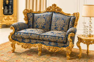 Luxury royal blue upholstered loveseat with antique gold hand-carved wooden frame, classic European-style furniture, and premium luxury seating.
