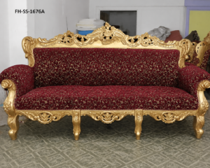 A luxurious handcrafted Baroque-style sofa featuring an intricately carved solid wood frame with an antique gold finish, rich burgundy floral upholstery, and elegant European-inspired detailing. Designed to enhance luxury living rooms, hotels, villas, and premium reception spaces with timeless sophistication.