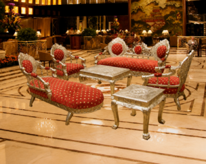 A luxurious Victorian-inspired lounge sofa set featuring premium red patterned upholstery, an intricately hand-carved silver-finished solid wood frame, and elegant European craftsmanship. Complete with matching coffee tables, this sofa set is ideal for luxury homes, hotels, lounges, and reception spaces.