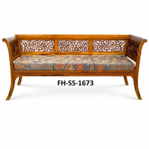 A beautifully handcrafted wooden sofa bench featuring intricate floral carvings on the backrest and frame, a rich wooden finish, and comfortable patterned cushioned seating. Designed with traditional craftsmanship, this elegant bench adds a royal touch to living rooms, lounges, and premium interiors.  Short Description