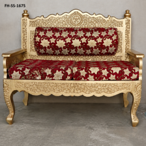 A premium handcrafted wooden bench featuring exquisite Kashmiri-inspired floral carvings, an elegant antique gold finish, and luxurious red floral upholstered cushions. Built with solid wood and traditional craftsmanship, this bench adds timeless elegance to living rooms, hallways, hotels, and heritage-inspired interiors.
